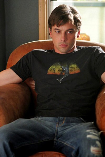 Jake (Skeet Ulrich) sits frowning.